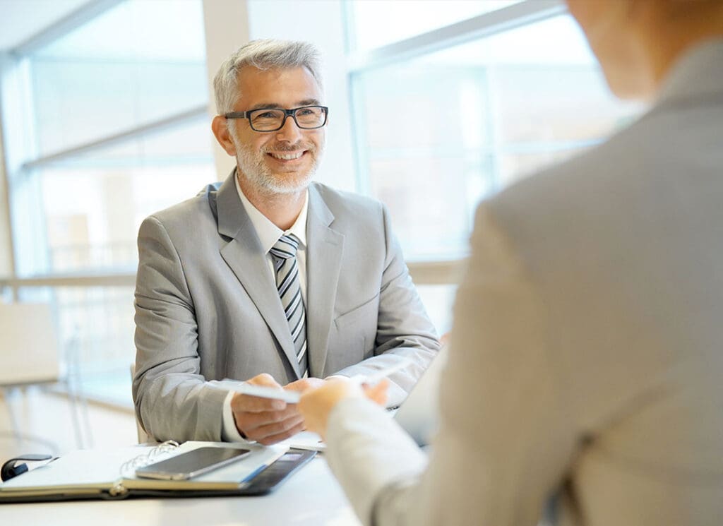 Landing Page - About Our Agency Insurance Agent Meeting with a Client